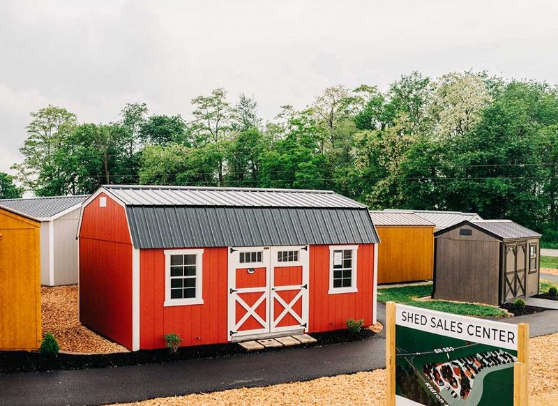 6581d81b9a7b22ce6fdf1fd9 red shed with barn doors on path with sign in front p 800