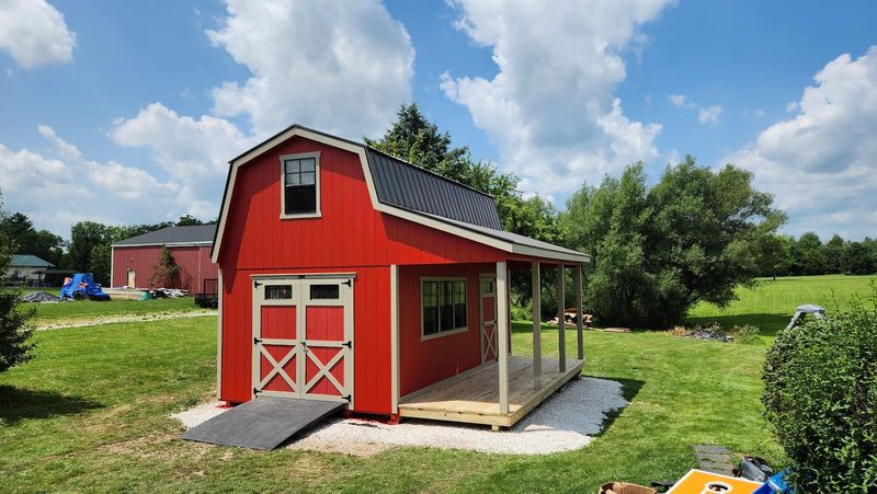 red shed with barn doors and porch p 800